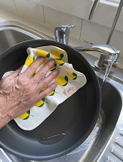 Man washing pan in sink with Lovely for Planet bamboo dishcloth